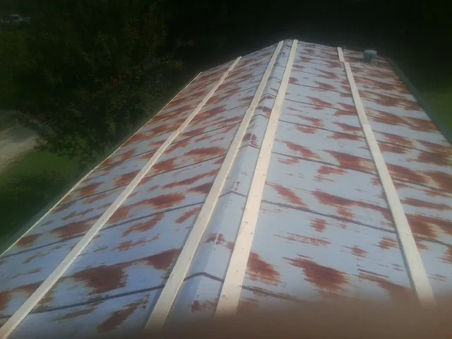 Rusted metal roof panels with new wood purlins before replacement — Storm Damage Roof Repair in Westley by Roofing Brothers